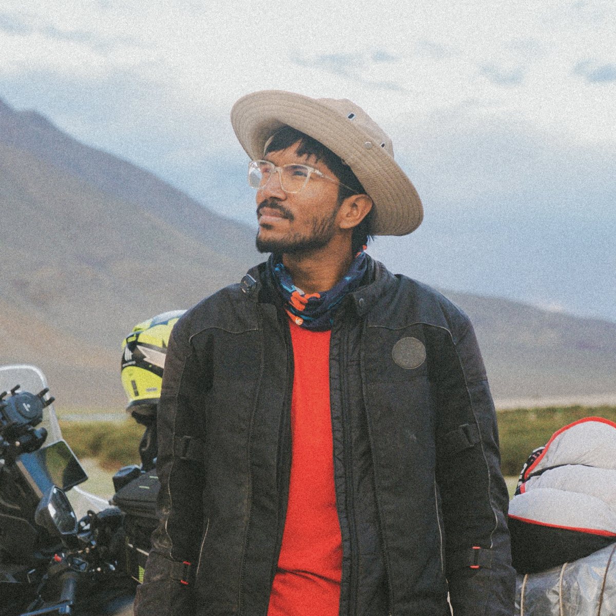 CineVik on location in the mountains, beside a loaded motorcycle